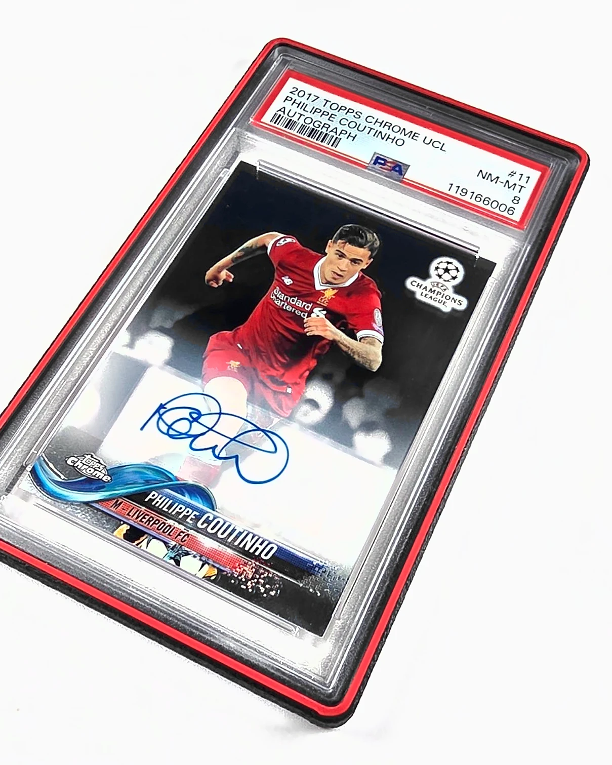 A black 3D printed bumper with a scarlet red ring around a PSA graded Philippe Coutinho card, photographed at an angle